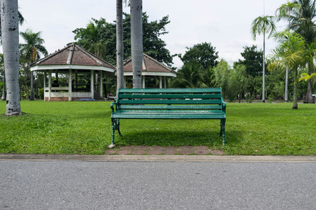 empty green bench in public park of bangkok, thailandの写真素材