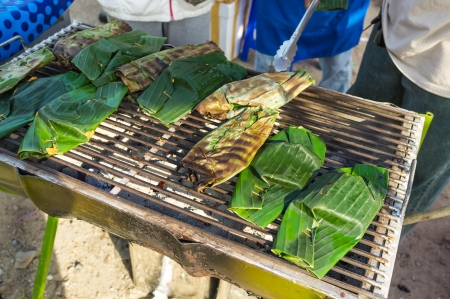 traditional asian street food grilled and covering with banana leafの写真素材