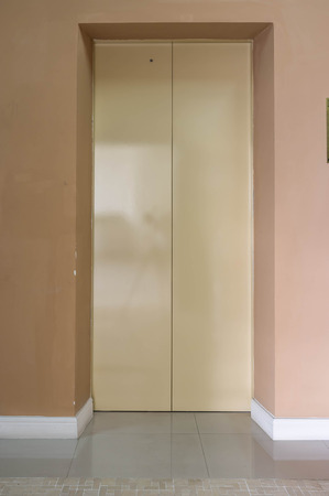 shiny classic elevator door in residential condominium