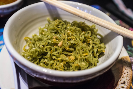 closeup shot of noodle in cup with chopstickの写真素材