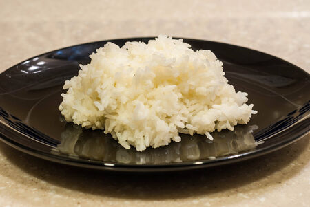 thailand famous food jasmine rice served in black ceramic plateの写真素材