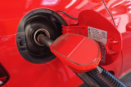 fuel pumping into modern car in gas stationの写真素材