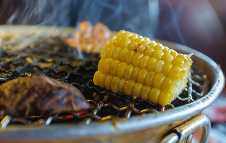 korean style grill corn in restaurantの写真素材