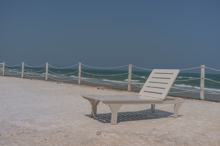 empty white day bed located by the sea in sunny day