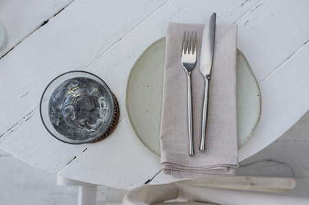 traditional western table setting with napkin, knife and fork