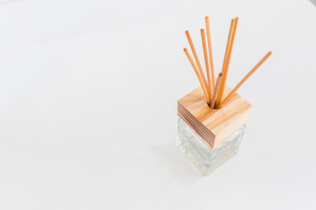 Aroma glass bottle  and perfume sticks on the tableの写真素材