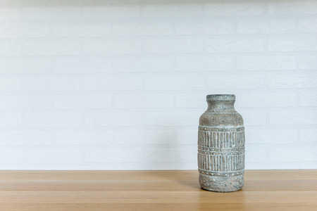 Pottery vase home accessory on the wood floor on white brick backgroundの写真素材