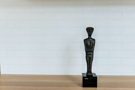 Doll home accessory on the wood floor on white brick backgroundの写真素材