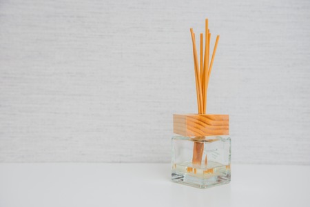 Aroma glass bottle and perfume stick on light background.Home accessoriesの写真素材