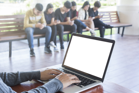group of smiling students and teacher with papers, laptop computer in classroomの写真素材