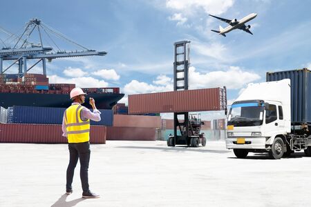 Foreman control loading Containers box from Cargo freight shipの写真素材