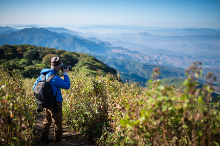 Professional photographer take landscape photos by camera on mountainon , travel , backpackの写真素材