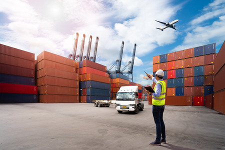 Foreman control loading Containers box to truck for Logistic Import Export Background, Business...