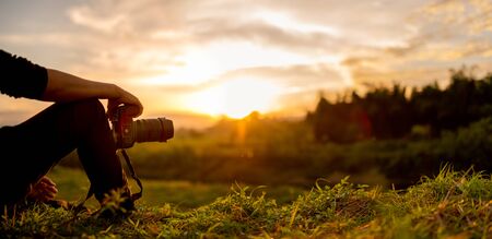 Nature photographer , Photographer are sitting look the sunsetの写真素材