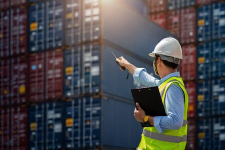 Foreman control loading Containers box to truck for Logistic Import Export Background, Business...