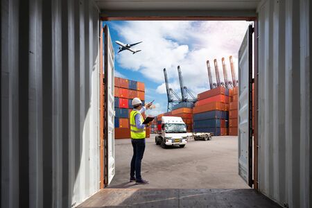 Foreman control loading Containers box to truck for Logistic Import Export Background, Business...