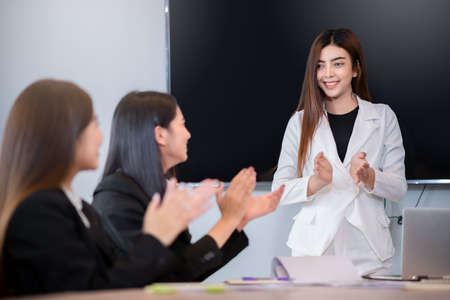 Group of asian young business people congratulating each other with good deal ,success and winningの写真素材