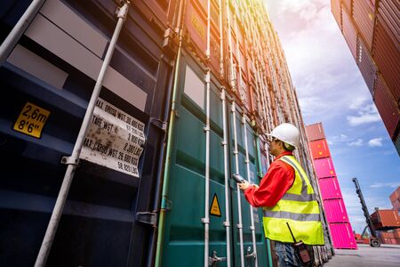 Foreman control loading Containers box from Cargo freight ship for import export, foreman control...