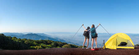female hikers enjoying on the top of cliff mountian.she enjoying the freedom in mountian mist on...