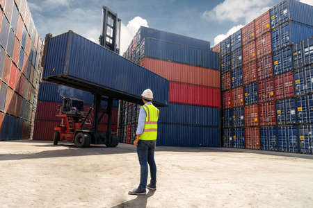 Foreman control loading Containers box to truck for Logistic Import Export Background, Business...