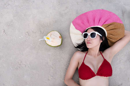 Sexy woman in the red bikini and sunhat on sea beach.travel summer beachの写真素材