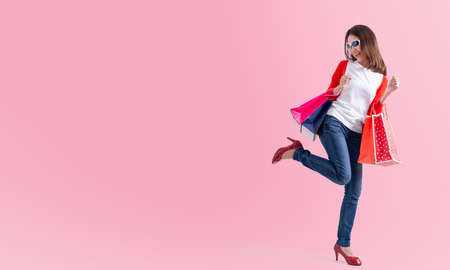 Young happy woman with shopping bags , Portrait of young happy smiling woman with shopping bags , advertisingの写真素材