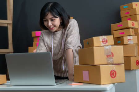 Young asian girl is freelancer with her private business at home office. Fashion designer stylish showroom conceptの写真素材