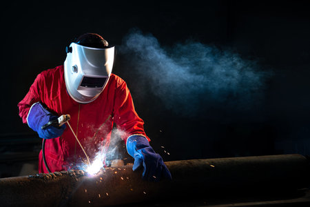 Industrial Worker welding on the pipeline construction at the factory weldingの写真素材