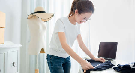 Young asian girl is freelancer with her private business at home office. Fashion designer stylish showroom conceptの写真素材