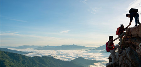 Asian hiking help each other on mountains view . teamwork conceptの写真素材