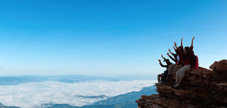 Group of happy hiker raised up arms on the hill. successful climbersの写真素材
