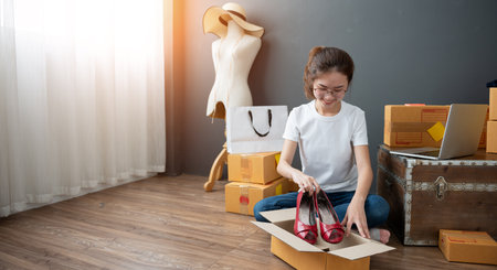 Young asian girl is freelancer with her private business at home office. Work From Home conceptの写真素材