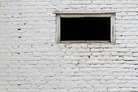 White brick wall with a window, building structures, abandoned building