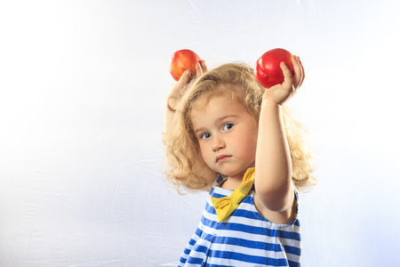 little girl holding a peach,harvesting, garden work, family, happiness smile fruitの写真素材