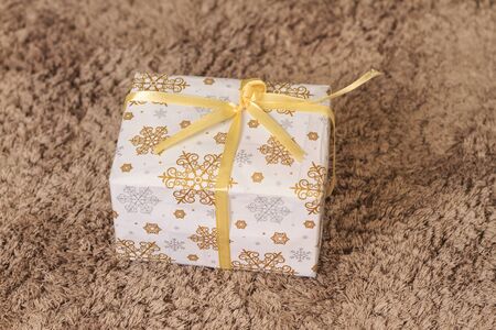 Christmas and New Year white gift under the tree on the rug,christmas, new year, symbol holidays,...