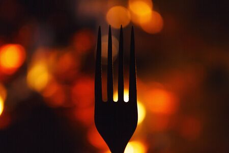 fork on a background of smoldering coals,silhouettes, hell kitchen, a creative restaurantの写真素材