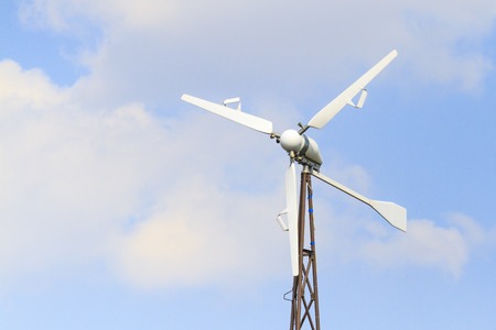 wind turbine on the background of blue sky and white clouds, new technologies, optimization of...