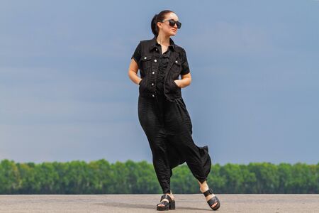 girl in black posing on the roadの写真素材
