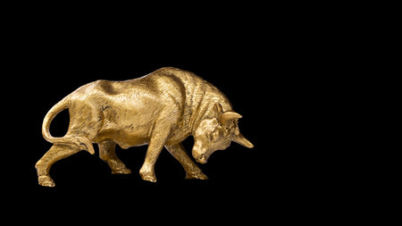 metal golden bull isolated on black backgroundの写真素材