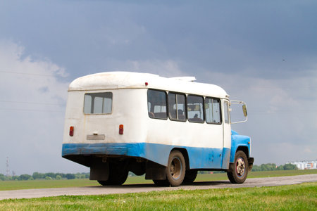 vintage bus driving on country road, journey