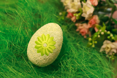 Decorative egg on green grass. Concepts Easter, eggs, hand made
