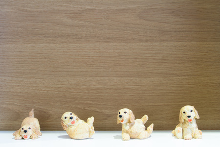 A puppy statue against a wood backgroundの写真素材