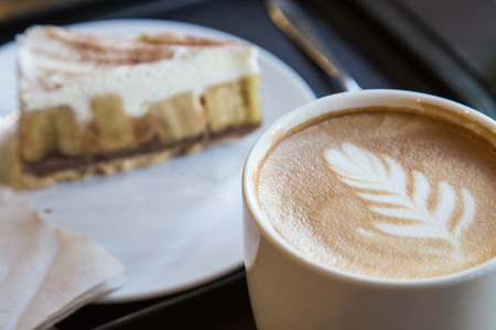 Hot coffee and blur banoffee pie backgroundの写真素材