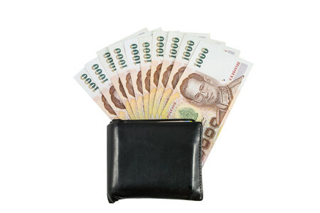 Thai money in black leather wallet isolated with white backgroundの写真素材