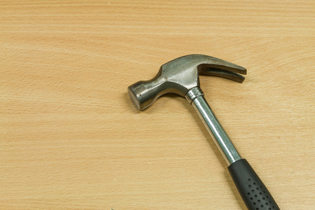 Iron hammer on wooden table backgroundの写真素材
