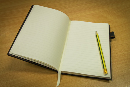 pencil and notebook with blank page on office table, business concept, vintage style