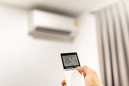 Hand press button on remote control air conditionerの写真素材