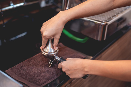 Barista preparing coffee beans grinded for make espresso shotの写真素材