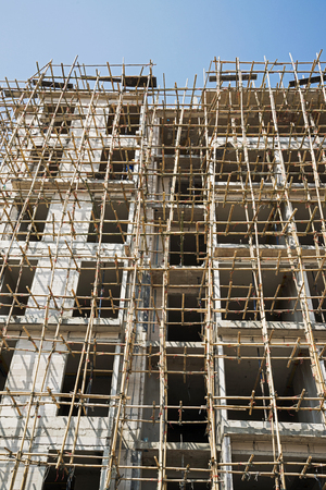 bamboo scaffolding in structure building on blue skyの写真素材