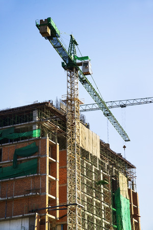 Construction site with cranes on sky backgroundの写真素材